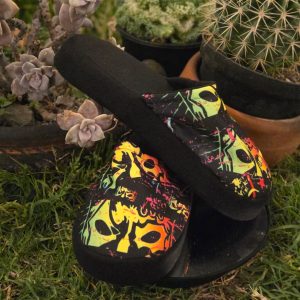 Pantuflas Traumas.mx – "Home Rudo Home" Dales a tus pies el descanso que se merecen con las nuevas Pantuflas de Traumas.mx. Este modelo ha sido creado para los fanáticos que buscan confort sin sacrificar la identidad de la Dinastía Navarro. Con una silueta clásica y fácil de usar, estas pantuflas destacan por su llamativo estampado de máscaras de lucha libre en colores neón, diseñado para vibrar en cualquier entorno doméstico.
